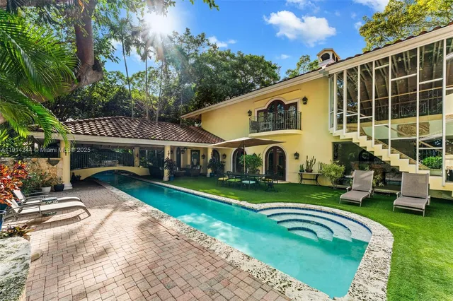 a view of a house with backyard porch and sitting area