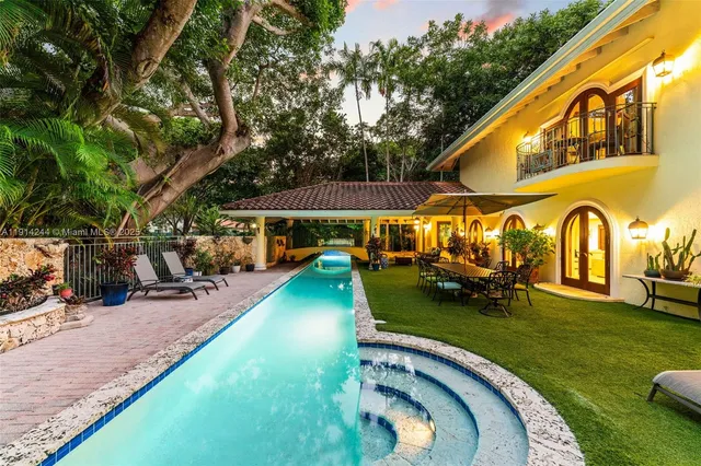 a view of a house with backyard porch and sitting area