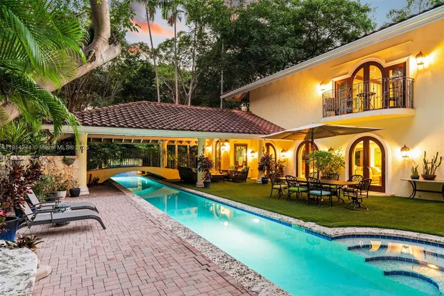 a view of swimming pool with garden and trees