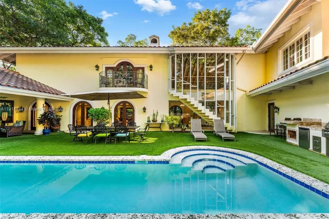 an aerial view of a city with lots of residential buildings and mountain view in back