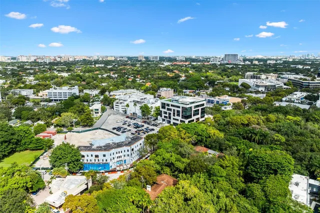 an aerial view of a house with yard and outdoor seating