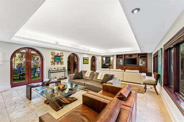 a living room with furniture fireplace and a large window