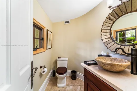 a bathroom with a sink mirror and toilet