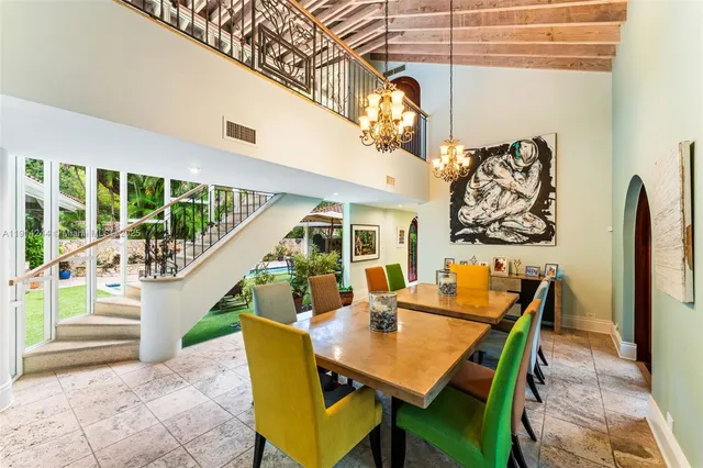 a dining room with furniture and wooden floor