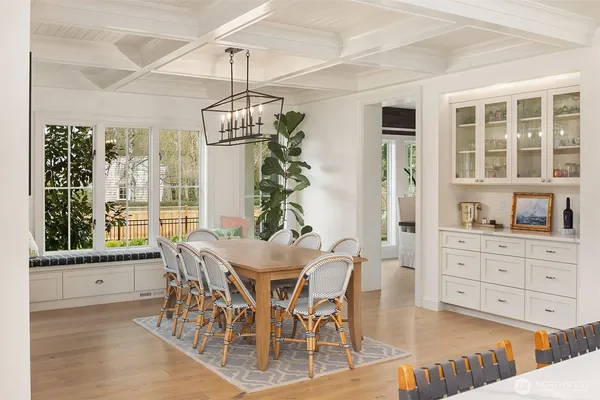 a view of a dining room with furniture large windows and wooden floor
