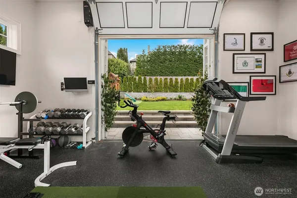 a room with gym equipment and a large window