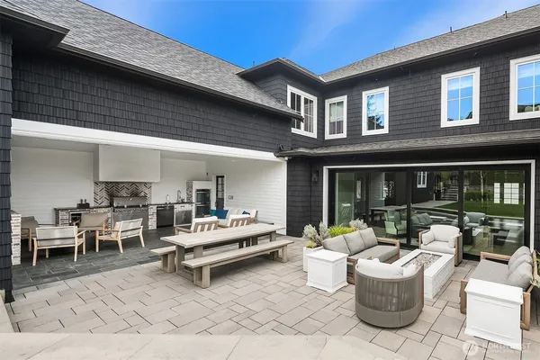 a view of a patio with couches table and chairs and potted plants