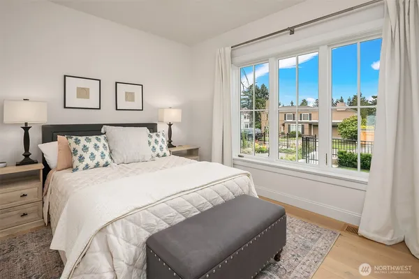 a bedroom with a large bed and a window