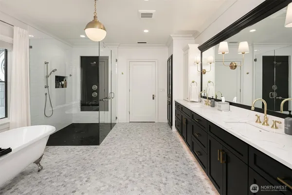 a large bathroom with a double vanity sink a large mirror and a bathtub