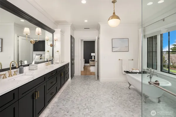 a large bathroom with a double vanity sink a large mirror and a bathtub