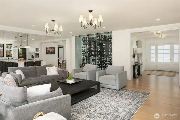 a living room with fireplace furniture and a chandelier