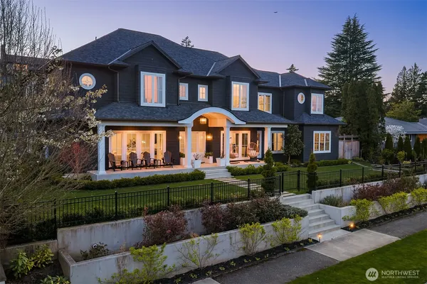 a front view of a house with a yard and outdoor seating