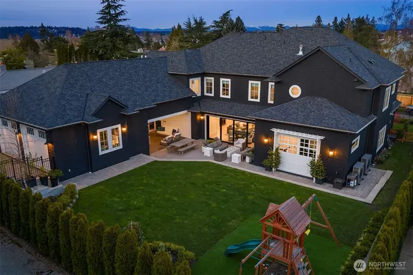a aerial view of a house with a yard table and chairs