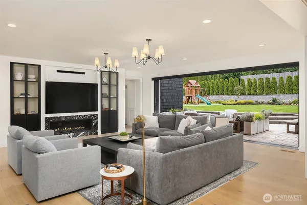 a living room with patio furniture and a flat screen tv