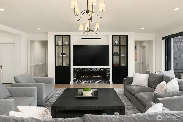 a living room with furniture a fireplace and a flat screen tv