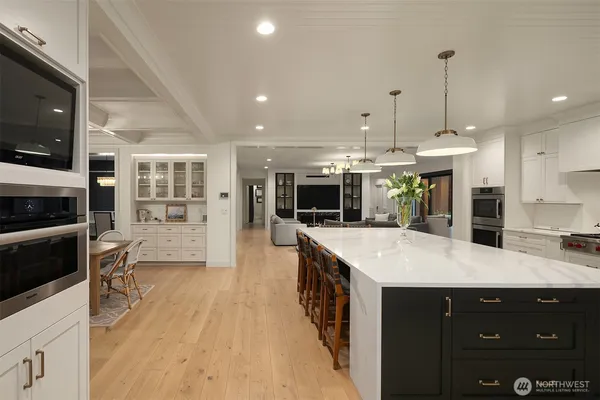 a large kitchen with kitchen island a sink stainless steel appliances and cabinets
