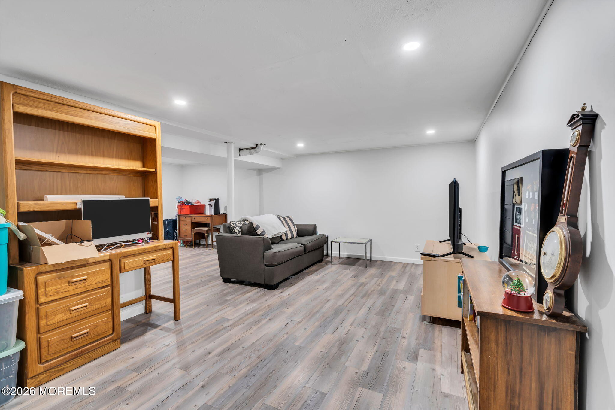 28 Oregon Avenue Jackson, NJ 08527 - Photo 22 of 33 a living room with furniture a flat screen tv and gym equipment