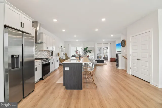 a kitchen with stainless steel appliances a refrigerator and cabinets