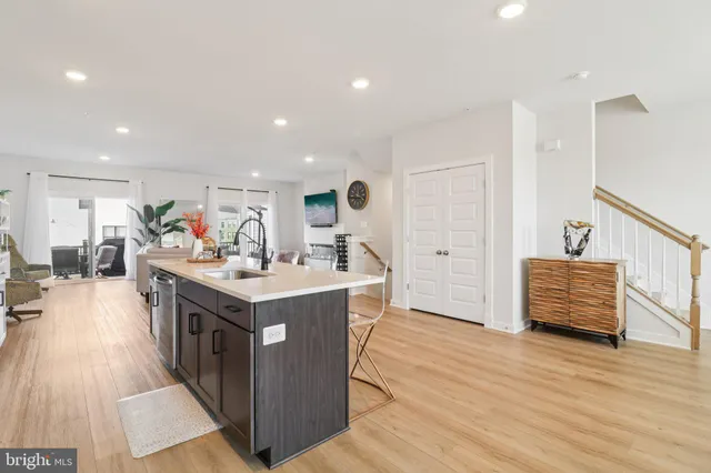a large kitchen with kitchen island a sink table and chairs