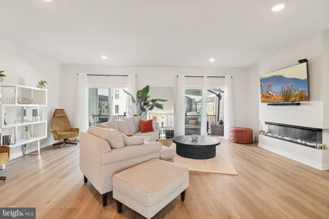 a living room with a fireplace and a wooden floor