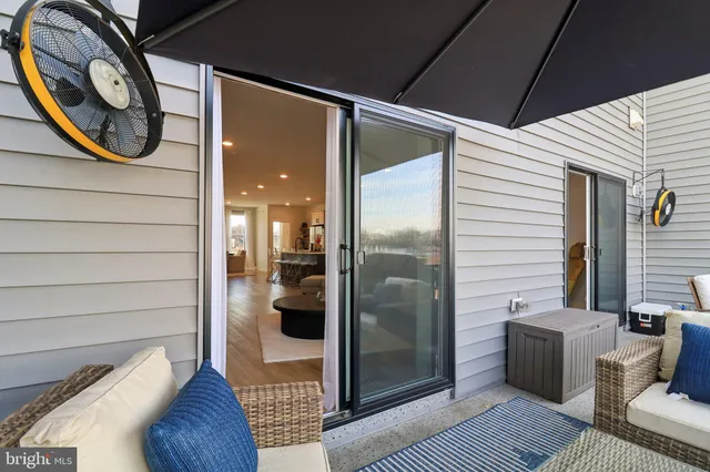 a balcony with furniture and a potted plant