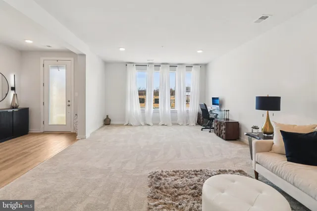 a view of a livingroom with furniture and staircase