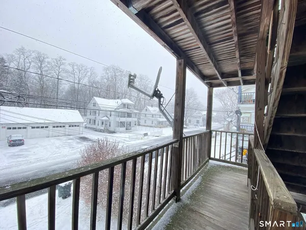 a view of balcony with wooden floor