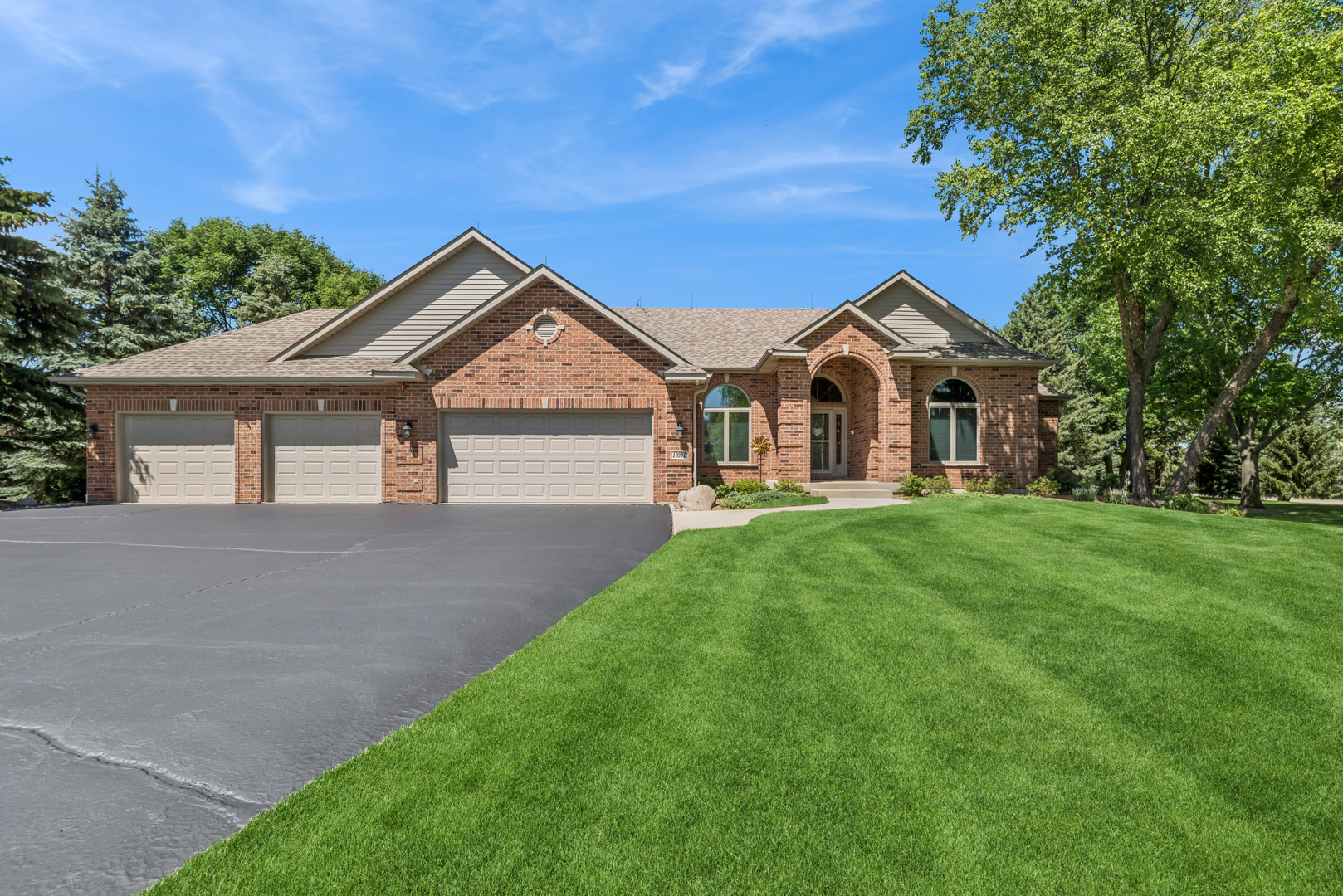 10907 Red Hawk Lane Spring Grove, IL 60071 - Photo 5 of 44 a front view of a house with a yard and garage