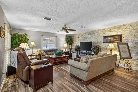 a living room with furniture fireplace and a flat screen tv