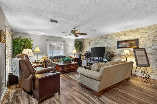 a living room with furniture fireplace and a flat screen tv