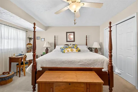 a bedroom with a bed and a chandelier