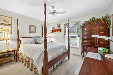 a bedroom with a bed and a desk