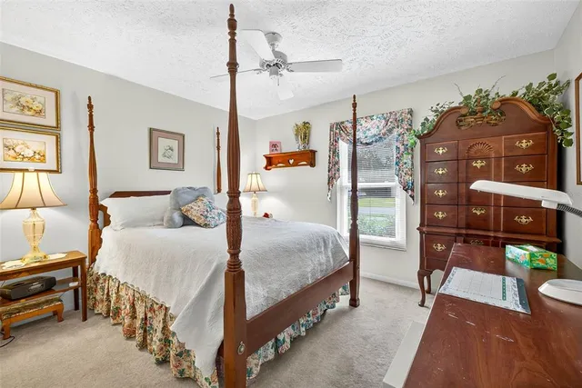 a bedroom with a bed and a desk