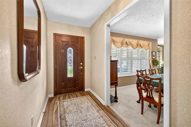 a view of front door with furniture and a window