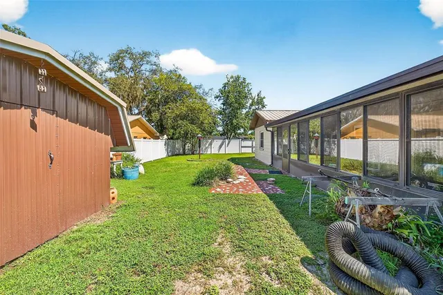 a view of a backyard with a garden and entertaining space