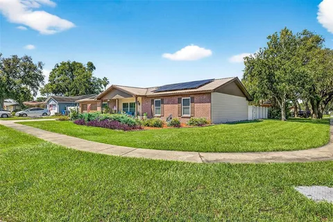 a front view of house with yard and green space