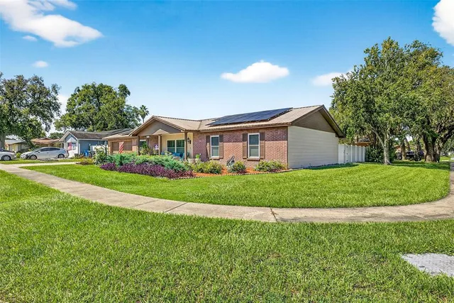 a front view of house with yard and green space