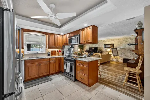 a kitchen with stainless steel appliances granite countertop a stove sink and cabinets