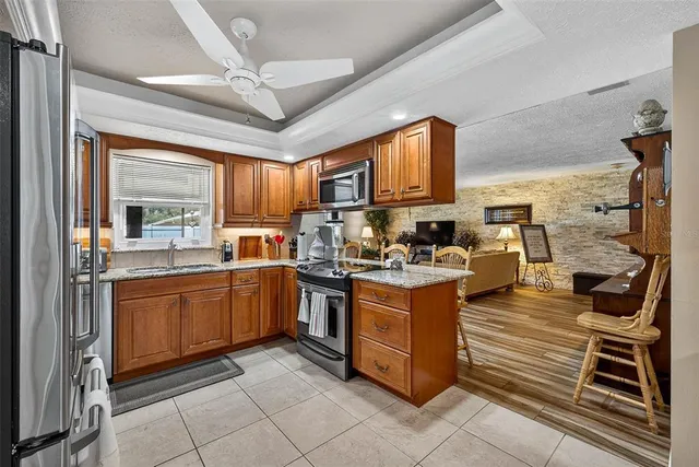a kitchen with stainless steel appliances granite countertop a stove sink and cabinets