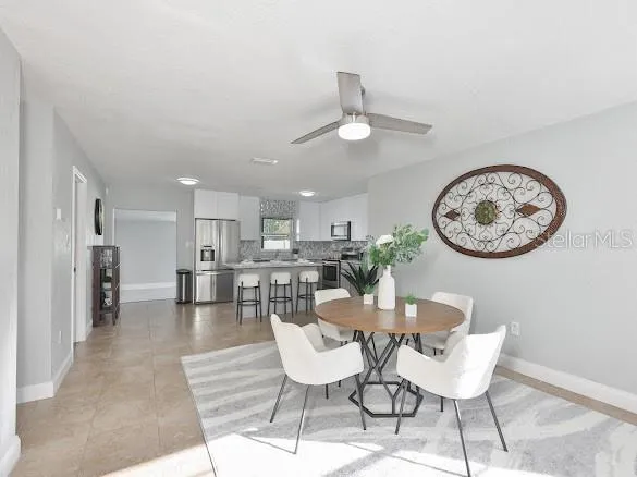 a view of a dining room with furniture and a clock