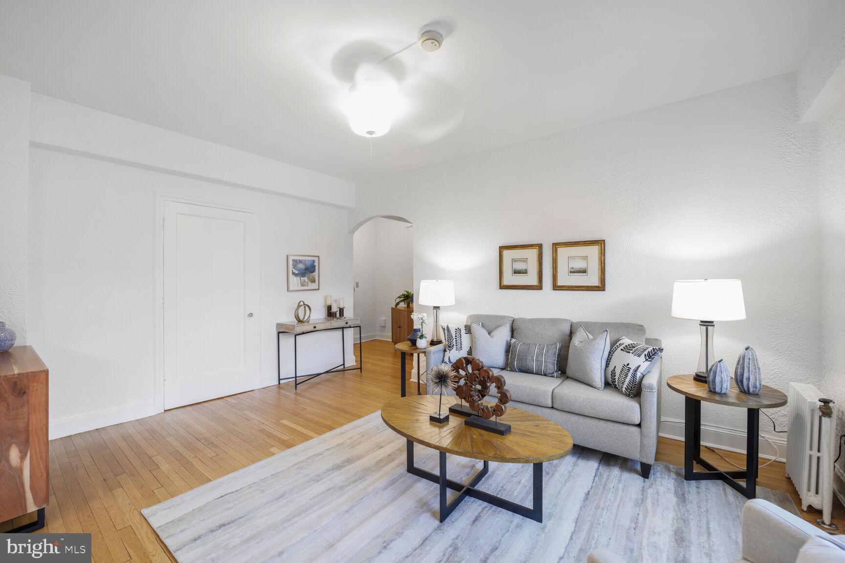 2032 Belmont Road Northwest, Unit 336 Washington, DC 20009 - Photo 17 of 23 a living room with furniture and a wooden floor
