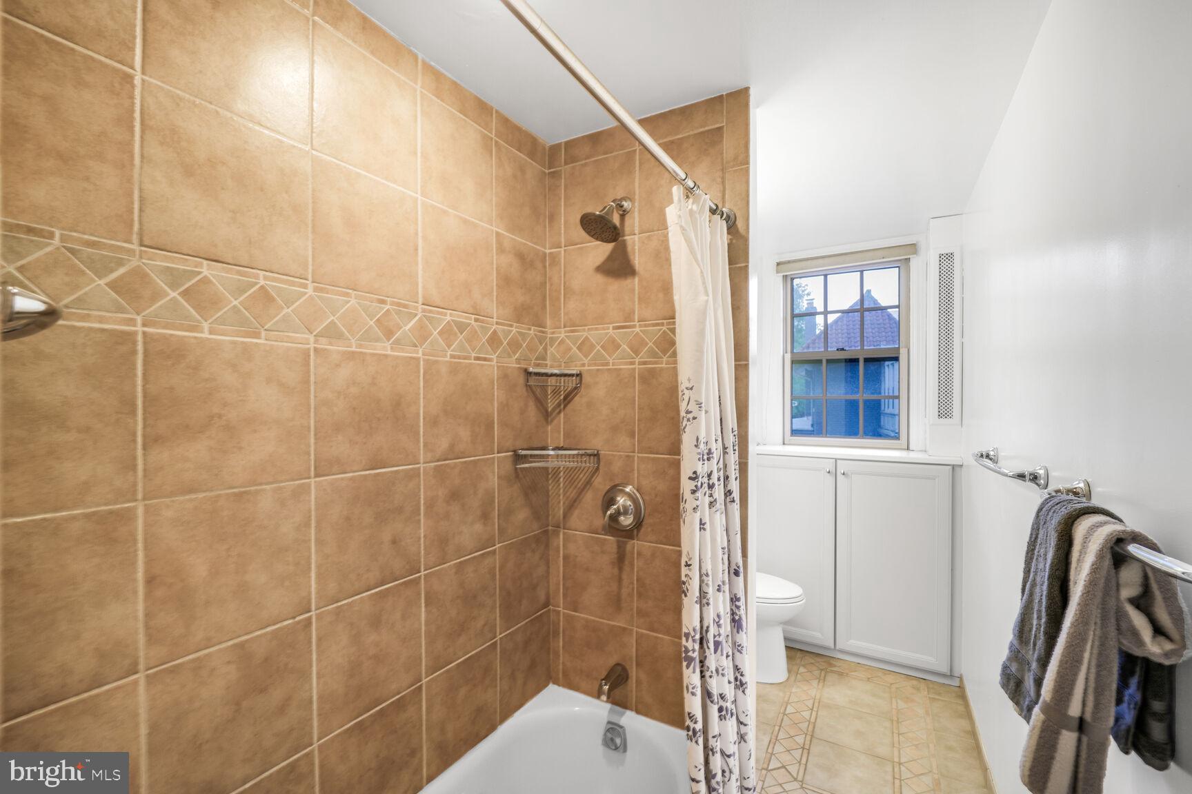 2032 Belmont Road Northwest, Unit 336 Washington, DC 20009 - Photo 18 of 23 a bathroom with a shower and a sink