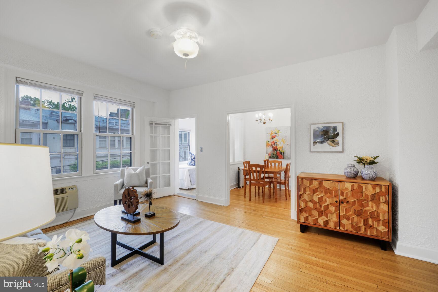 2032 Belmont Road Northwest, Unit 336 Washington, DC 20009 - Photo 2 of 23 a living room with furniture and a wooden floor