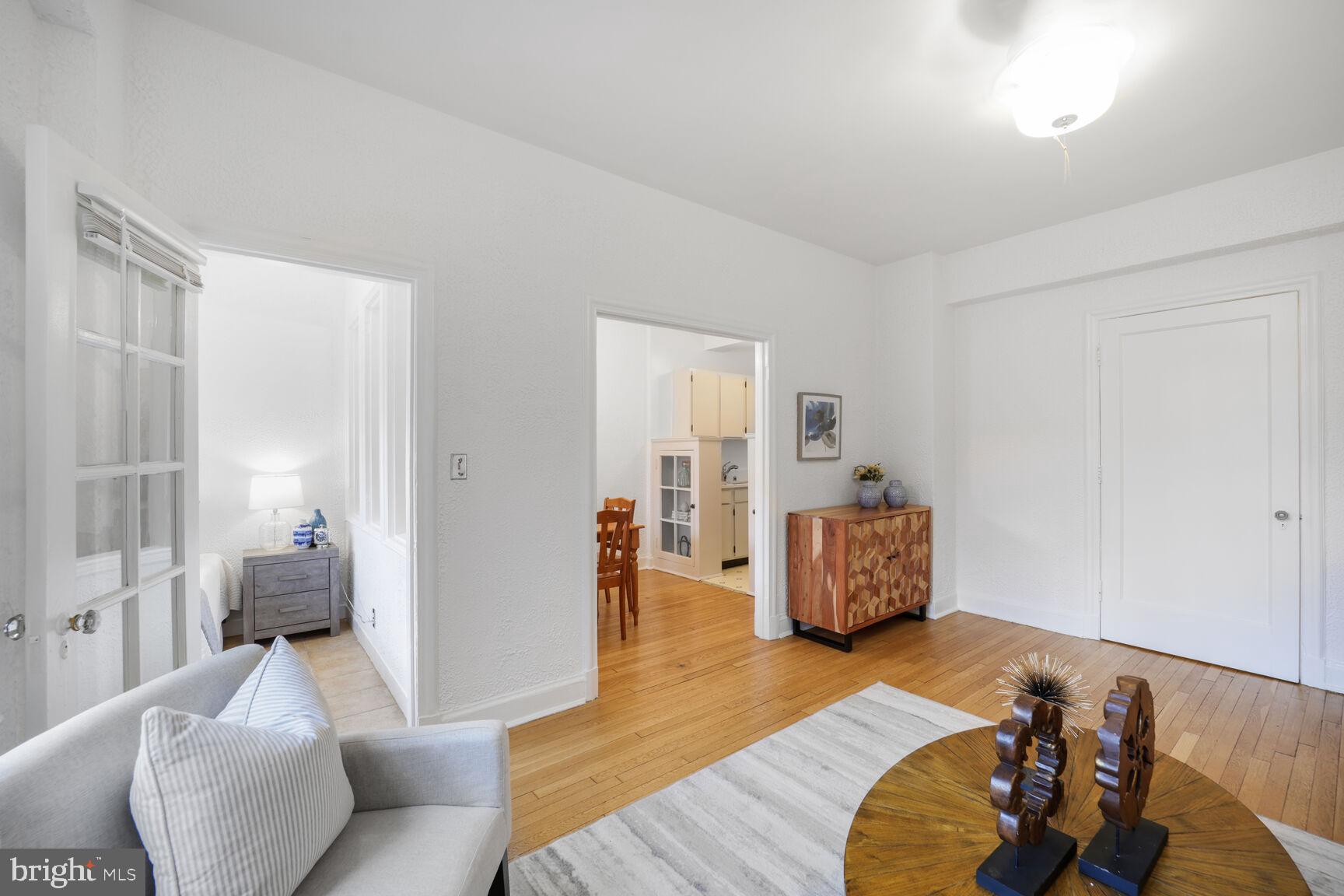 2032 Belmont Road Northwest, Unit 336 Washington, DC 20009 - Photo 5 of 23 a living room with furniture and wooden floor