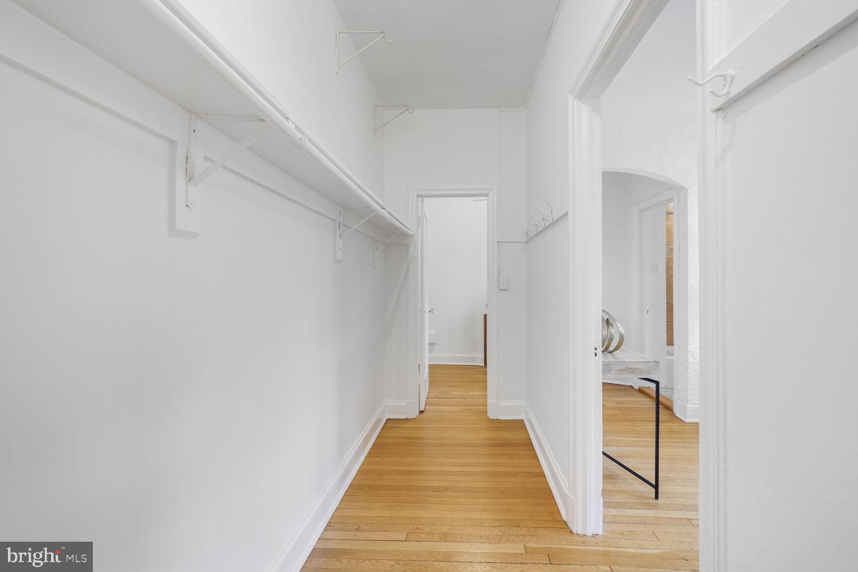 2032 Belmont Road Northwest, Unit 336 Washington, DC 20009 - Photo 6 of 23 a view of a hallway with wooden floor and staircase
