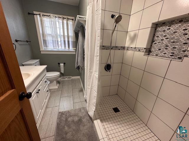 62 Elm Boulevard Babbitt, MN 55706 - Photo 13 of 21 Bathroom with tiled shower, toilet, and vanity