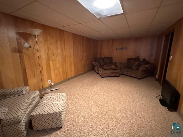 62 Elm Boulevard Babbitt, MN 55706 - Photo 15 of 21 Living area with wooden walls, light colored carpet, visible vents, and a drop ceiling