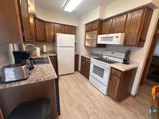 62 Elm Boulevard Babbitt, MN 55706 - Photo 2 of 21 Kitchen with white appliances, light countertops, light wood-style floors, and a sink