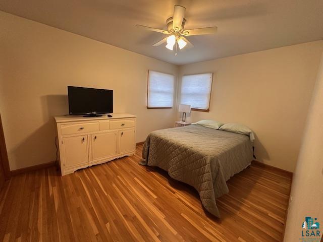 62 Elm Boulevard Babbitt, MN 55706 - Photo 8 of 21 Bedroom featuring ceiling fan, baseboards, and light wood-style floors