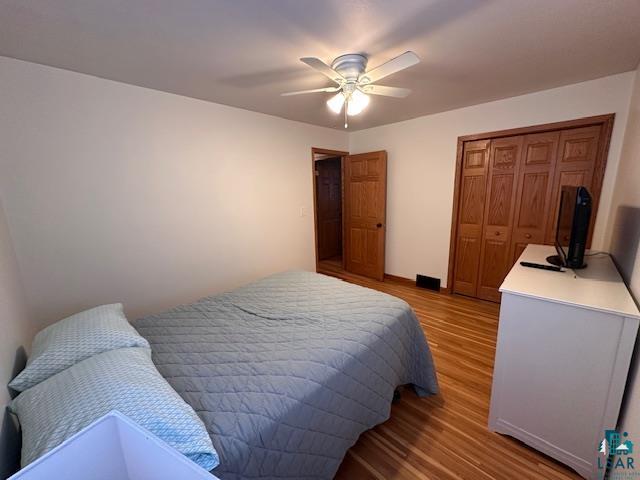 62 Elm Boulevard Babbitt, MN 55706 - Photo 9 of 21 Bedroom featuring a ceiling fan, visible vents, wood finished floors, and a closet
